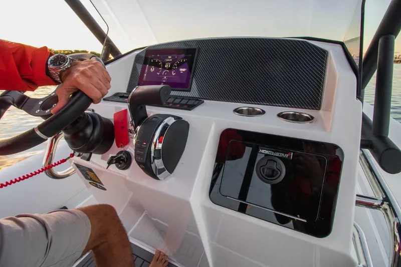 Slide: The Image of 2024 Northstar Orion 8 boat dashboard with steering wheel and control panel. - 10
