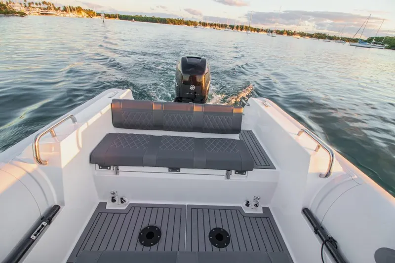 Slide: The Image of 2024 Northstar Orion 8 boat interior with outboard motor on calm water. - 13