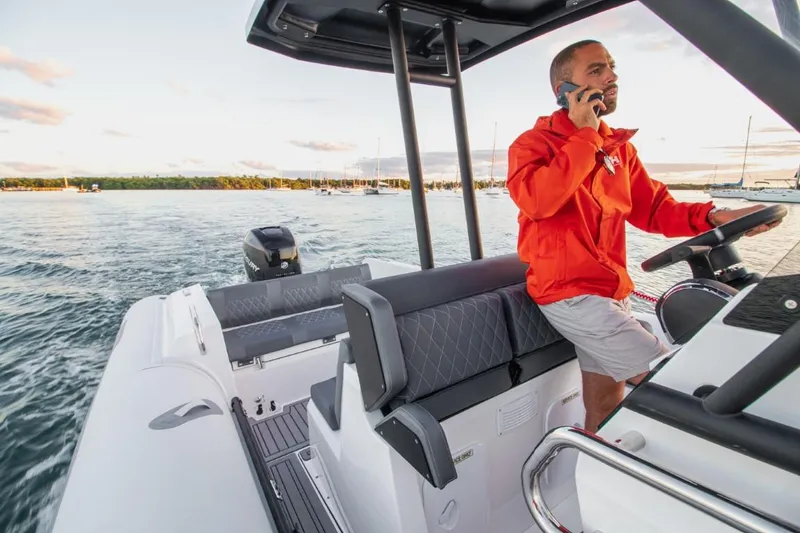 Slide: The Image of Man steering 2024 Northstar Orion 8 boat on water, talking on phone. - 9