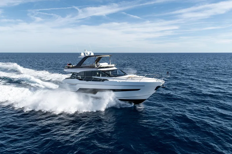 The Image of 2024 Fairline Squadron 68 yacht cruising on open sea under clear blue sky. - 0