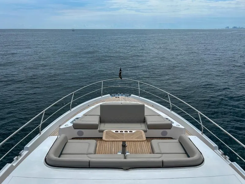 Slide: The Image of 2024 Fairline Squadron 68 yacht bow with luxurious seating and ocean view. - 10