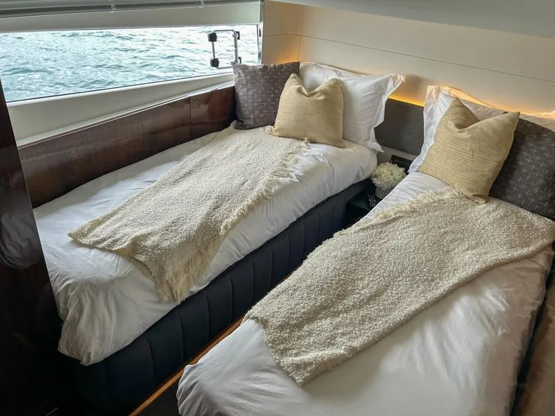 Slide: The Image of Twin beds in the 2024 Fairline Squadron 68 yacht cabin with ocean view. - 32