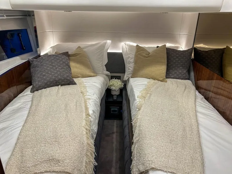 Slide: The Image of Luxurious twin cabin in 2024 Fairline Squadron 68 yacht with elegant bedding and ambient lighting. - 33