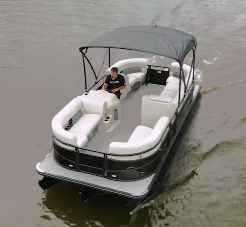 Slide: The Image of 2024 Vision Marine Technologies WX Tritoon cruising on water with canopy and seating. - 8