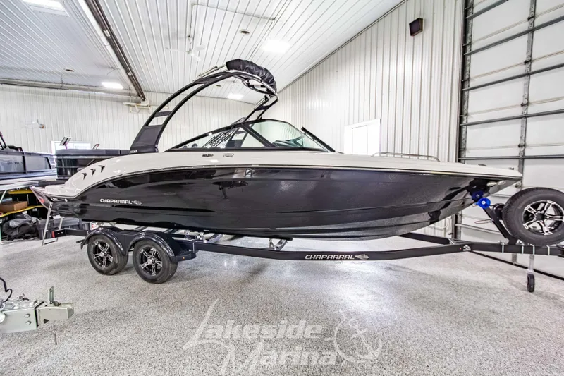 The Image of 2026 Chaparral 23 SSi boat on trailer in indoor showroom. - 1