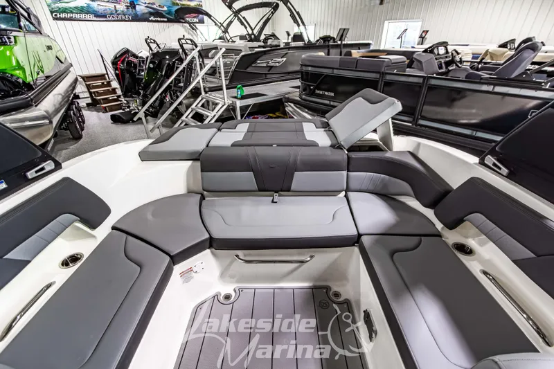 Slide: The Image of 2026 Chaparral 23 SSi boat interior with luxurious seating at Lakeside Marina showroom. - 15