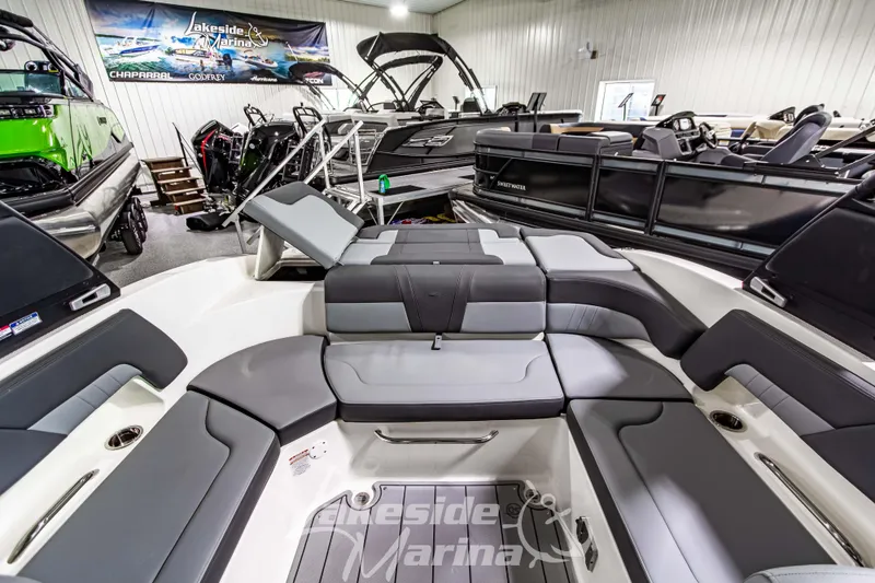 Slide: The Image of 2026 Chaparral 23 SSi boat interior with luxurious seating at Lakeside Marina showroom. - 16