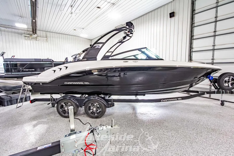 Slide: The Image of 2026 Chaparral 23 SSi boat on trailer in indoor showroom. - 2