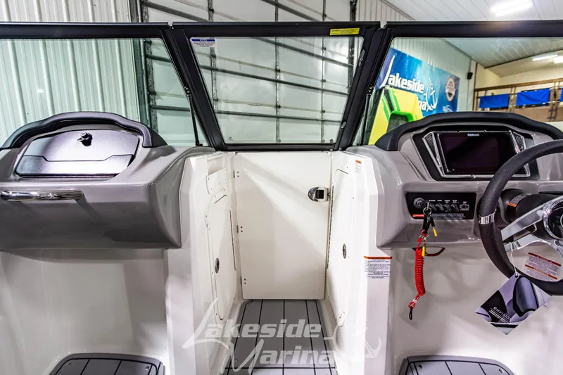 Slide: The Image of Interior view of 2026 Chaparral 23 SSi boat, featuring modern dashboard and steering wheel. - 23