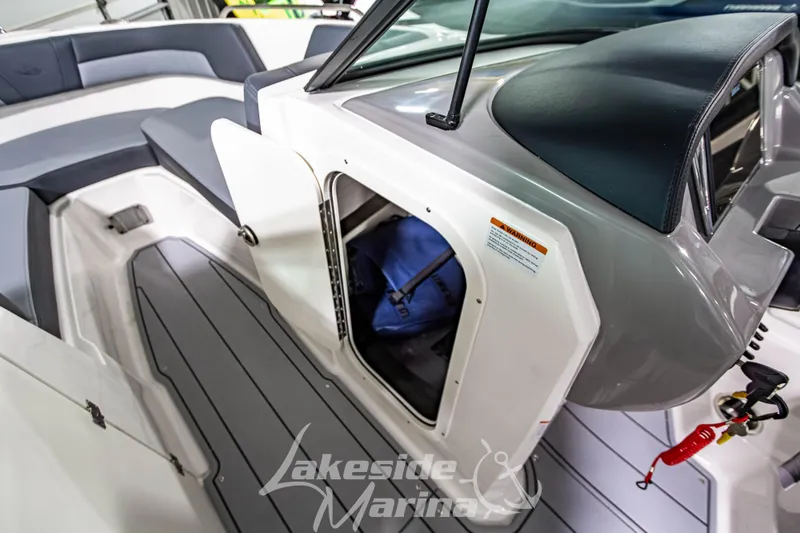Slide: The Image of 2026 Chaparral 23 SSi boat interior with storage compartment and seating area. - 25