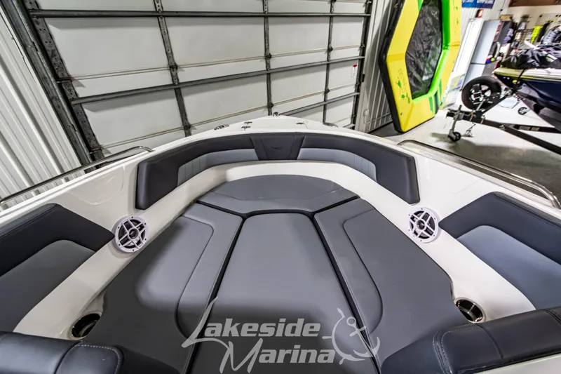 Slide: The Image of 2026 Chaparral 23 SSi boat interior with cushioned seating and speakers at Lakeside Marina. - 26