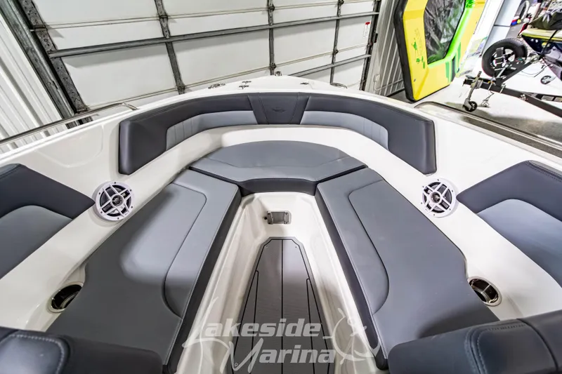 Slide: The Image of 2026 Chaparral 23 SSi boat interior with gray seating and speakers at Lakeside Marina. - 28