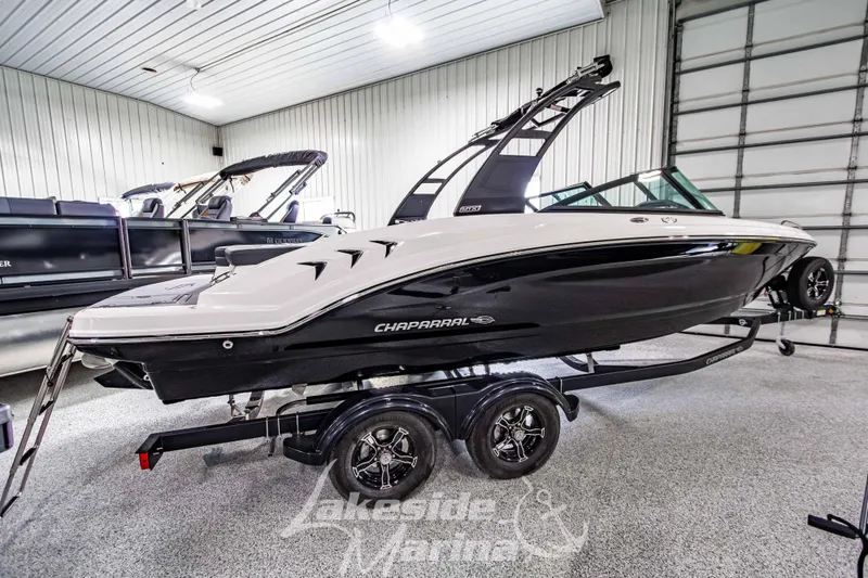 Slide: The Image of 2026 Chaparral 23 SSi boat in showroom, sleek design on trailer. - 3