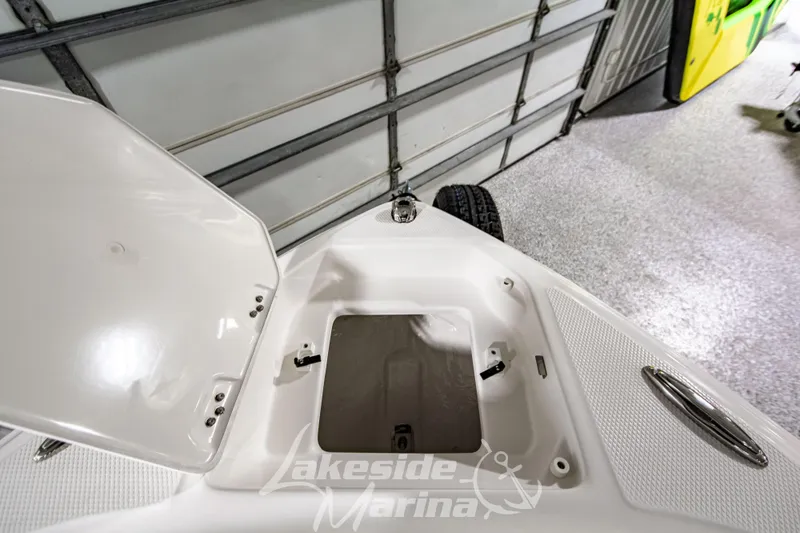 Slide: The Image of Open storage compartment on 2026 Chaparral 23 SSi boat in a garage setting. - 31