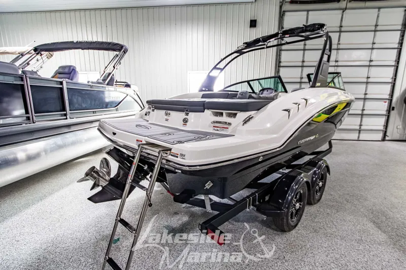 Slide: The Image of 2026 Chaparral 23 SSi boat on trailer in showroom, rear view. - 4