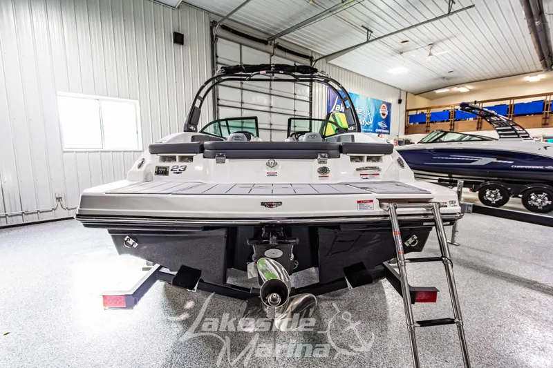 Slide: The Image of 2026 Chaparral 23 SSi boat in showroom, rear view with ladder and propeller. - 5