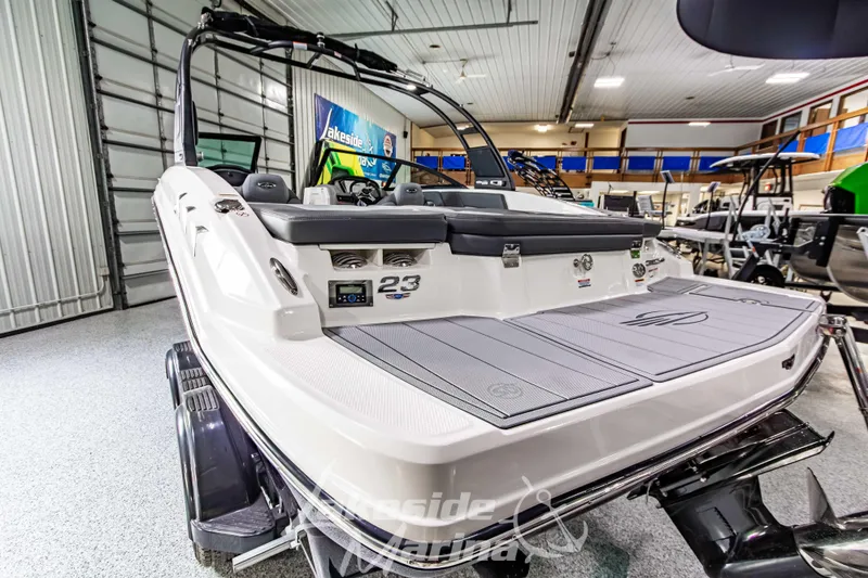 Slide: The Image of 2026 Chaparral 23 SSi boat displayed in a showroom, showcasing sleek design and modern features. - 6