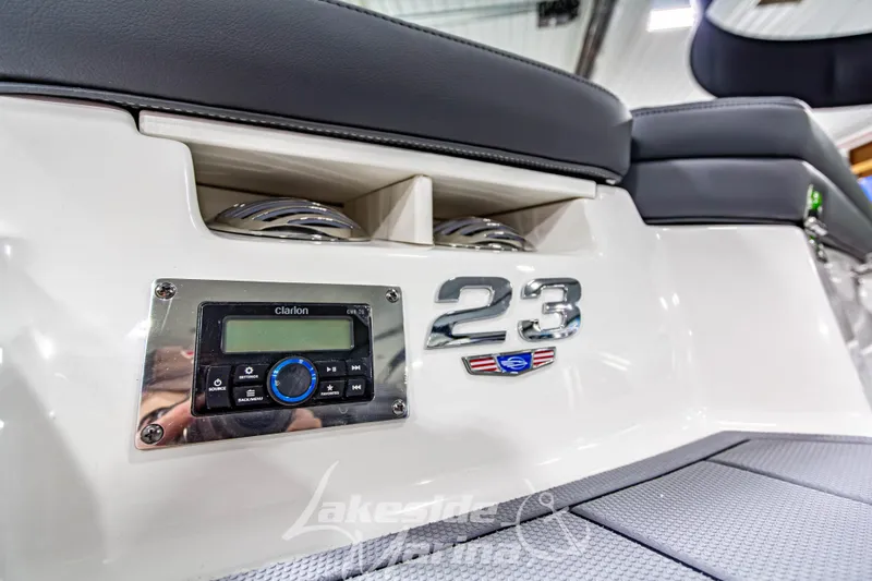 Slide: The Image of 2026 Chaparral 23 SSi boat interior with Clarion stereo system and sleek seating design. - 8
