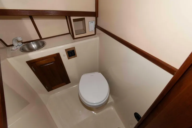 Slide: The Image of Bathroom interior of a 1996 Nordic Tug 26, featuring a toilet and sink. - 20