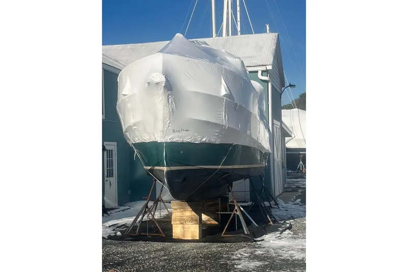 Slide: The Image of 1996 Nordic Tug 26 under protective cover, showcasing deck and support structure. - 4