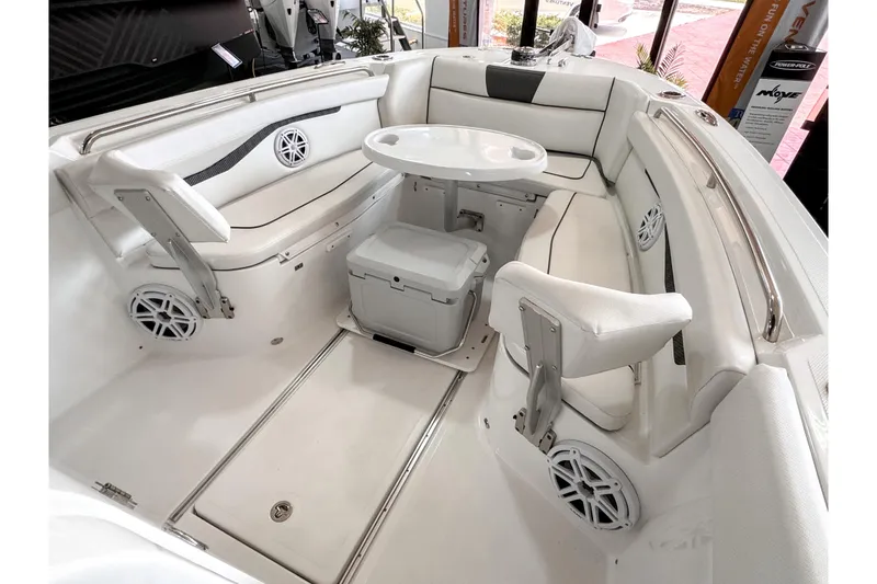 Slide: The Image of 2024 Wellcraft 263 Fisherman boat interior with seating, table, and speakers. - 15