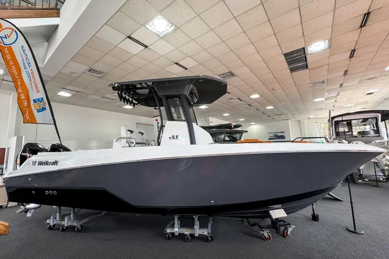 Slide: The Image of 2024 Wellcraft 263 Fisherman boat displayed in a showroom, side view. - 1