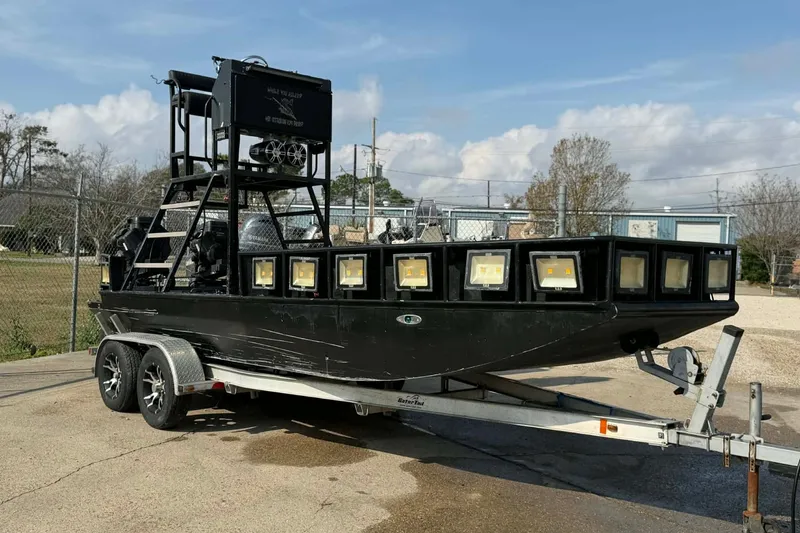 The Image of Custom 2015 Bowfishing boat on trailer with multiple lights, parked outdoors. - 0