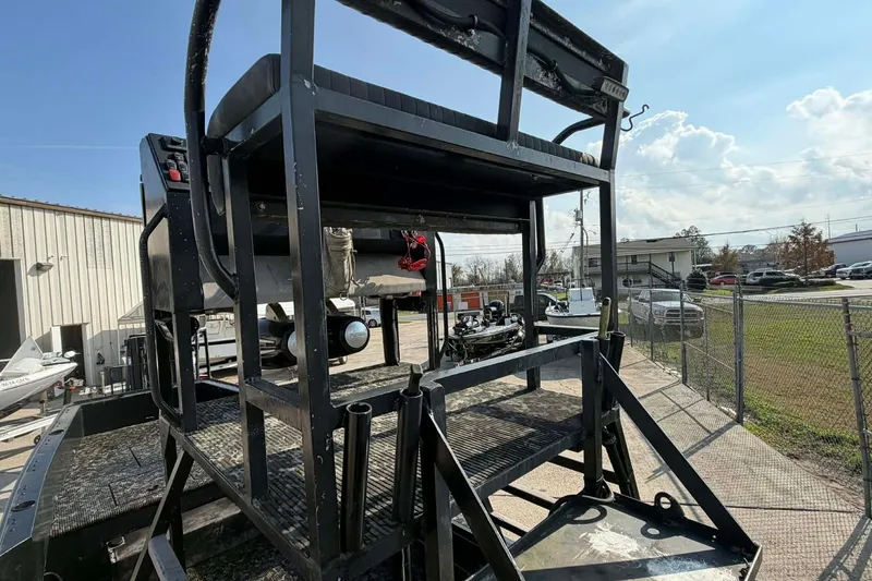 Slide: The Image of 2015 Custom 2175 Bowfishing boat with elevated platform, parked outdoors. - 3