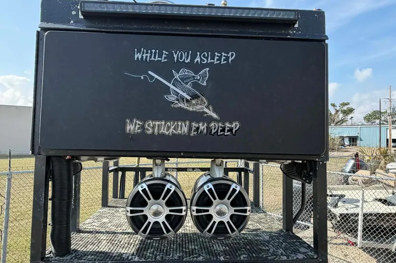 Slide: The Image of 2015 Custom 2175 Bowfishing boat with speakers and fishing-themed graphics. - 4