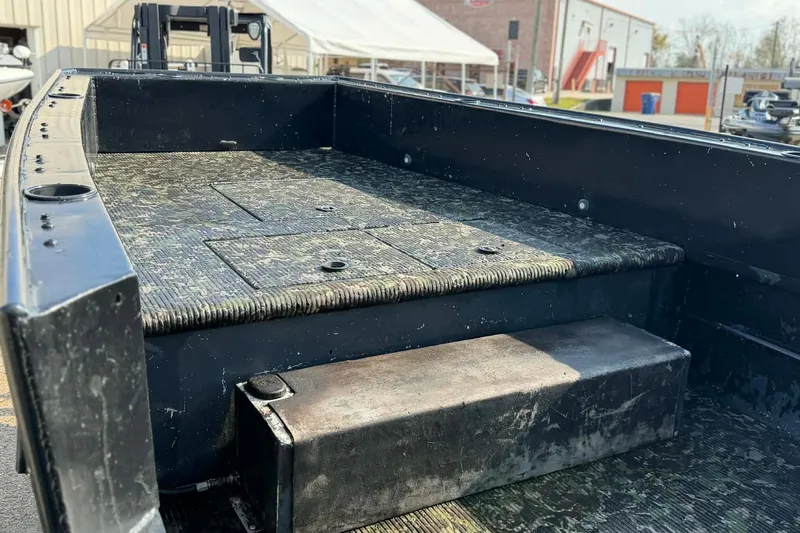 Slide: The Image of 2015 Custom 2175 Bowfishing boat interior with textured flooring and storage compartments. - 6