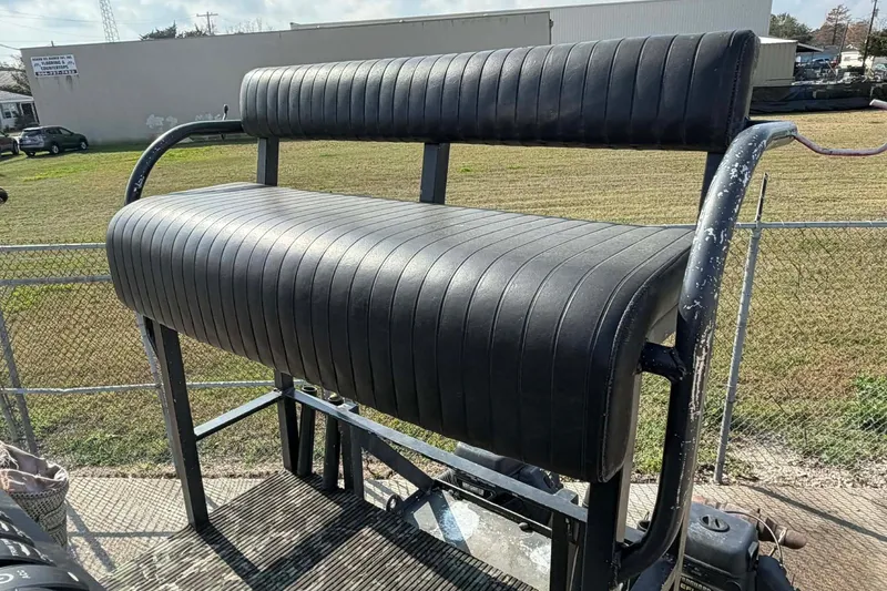 Slide: The Image of Black padded seat on a 2015 Custom 2175 Bowfishing boat, outdoor setting. - 7