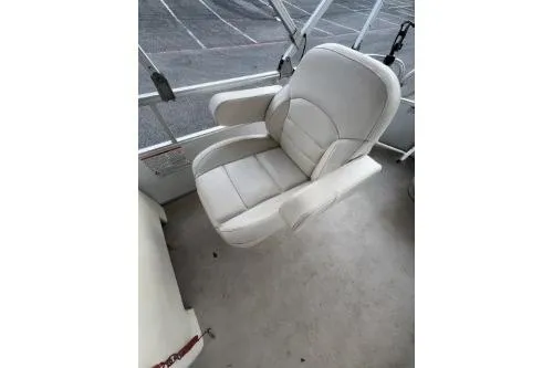 Slide: The Image of 2016 SunChaser Oasis 820 FNC boat seat, white upholstery, outdoor setting. - 10