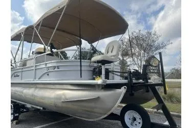 Slide: The Image of 2016 SunChaser Oasis 820 FNC pontoon boat with canopy, parked on a trailer. - 3