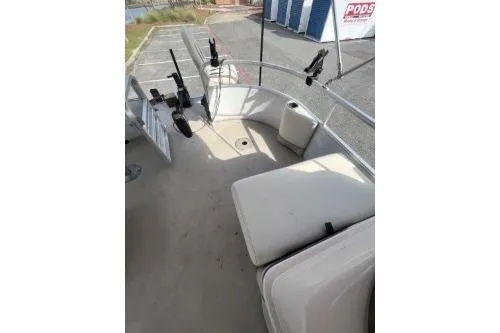 Slide: The Image of 2016 SunChaser Oasis 820 FNC boat interior with seating and fishing rod holders. - 6