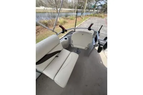 Slide: The Image of 2016 SunChaser Oasis 820 FNC boat interior with white seating and steering console. - 7