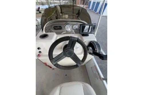 Slide: The Image of 2016 SunChaser Oasis 820 FNC boat dashboard with steering wheel and controls. - 9