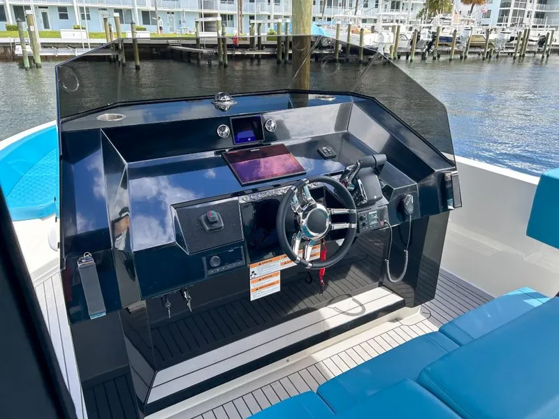 Slide: The Image of 2023 De Antonio Yachts D28 Open helm with modern controls and blue seating. - 10