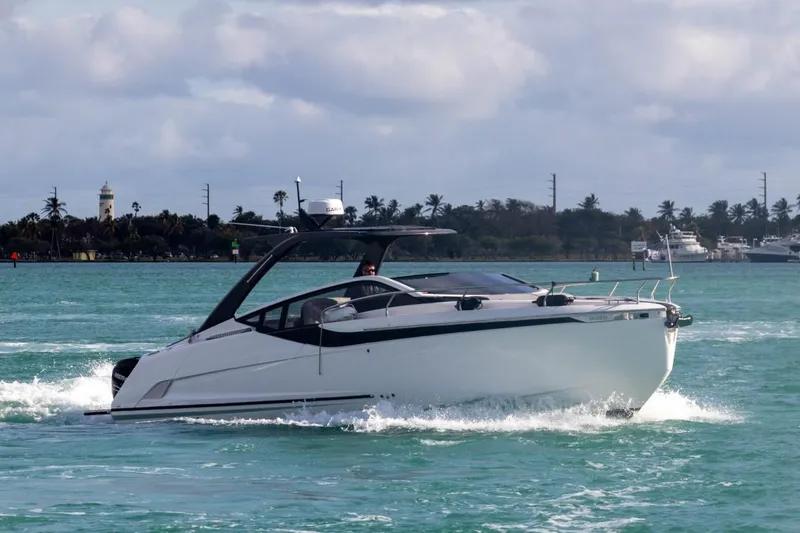 Slide: The Image of 2023 Fairline F//Line 33 Outboard cruising on turquoise water. - 6