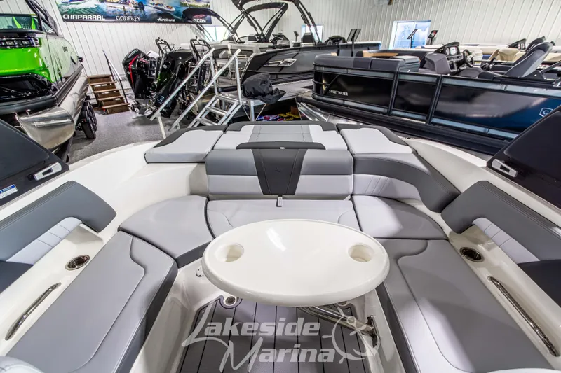 Slide: The Image of 2026 Chaparral 23 SSi boat interior with seating and table at Lakeside Marina. - 16