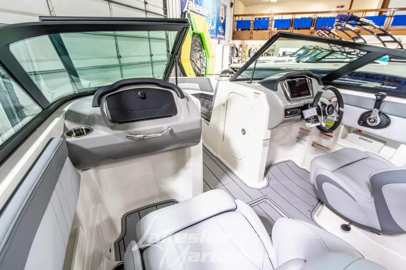 Slide: The Image of Interior view of 2026 Chaparral 23 SSi boat, featuring modern dashboard and seating. - 19
