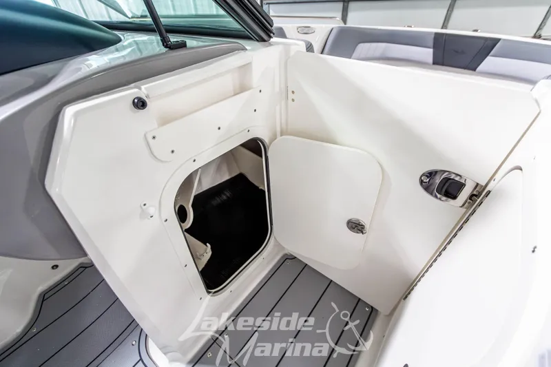 Slide: The Image of 2026 Chaparral 23 SSi boat interior storage compartment with open hatch. - 22