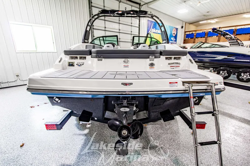 Slide: The Image of 2026 Chaparral 23 SSi boat in showroom, rear view with swim platform and ladder. - 4