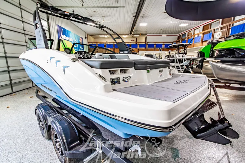 Slide: The Image of 2026 Chaparral 23 SSi boat in showroom, featuring sleek design and modern amenities. - 5