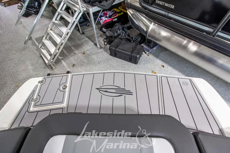 Slide: The Image of 2026 Chaparral 23 SSi boat deck in marina, featuring sleek design and logo. - 9