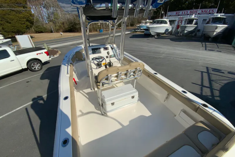 Slide: The Image of 2019 Key West 239 FS boat interior at dealership, featuring console and seating. - 11