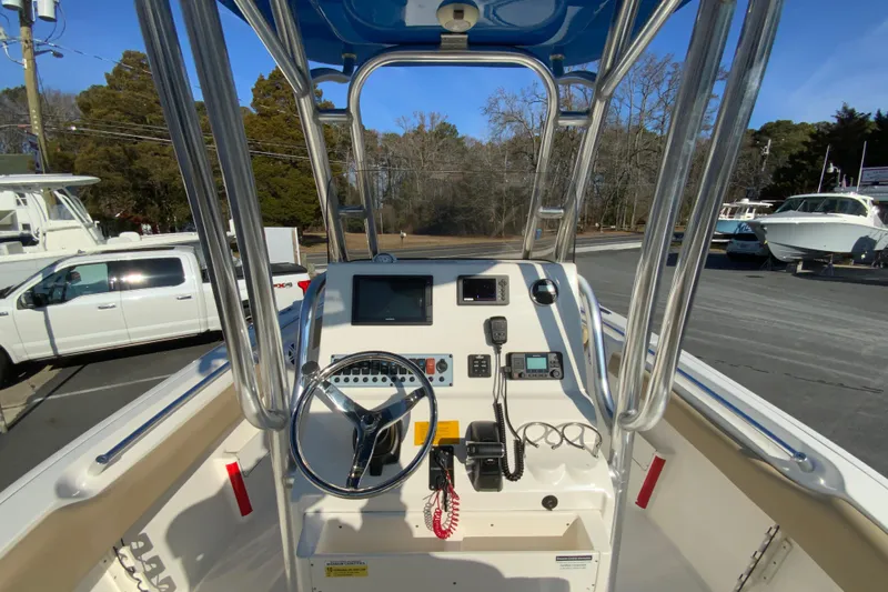 Slide: The Image of 2019 Key West 239 FS boat dashboard with steering wheel and navigation equipment. - 12