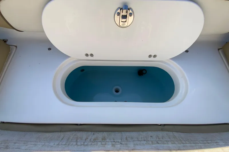 Slide: The Image of 2019 Key West 239 FS boat livewell with open lid and blue interior. - 19