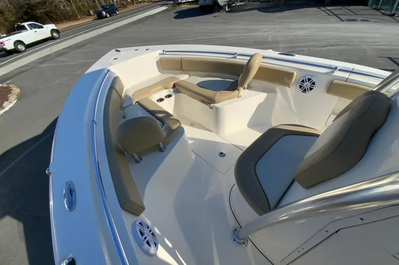 Slide: The Image of 2019 Key West 239 FS boat interior with beige seating and cup holders. - 22