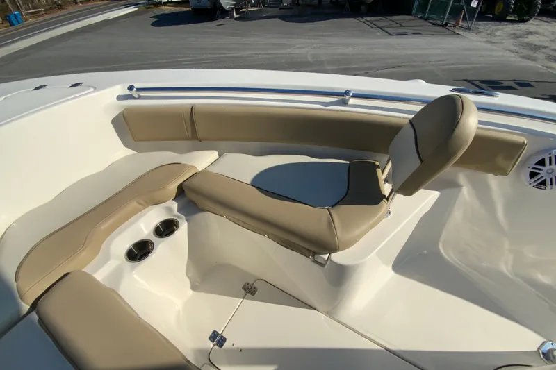 Slide: The Image of 2019 Key West 239 FS boat interior with beige seating and cup holders. - 23