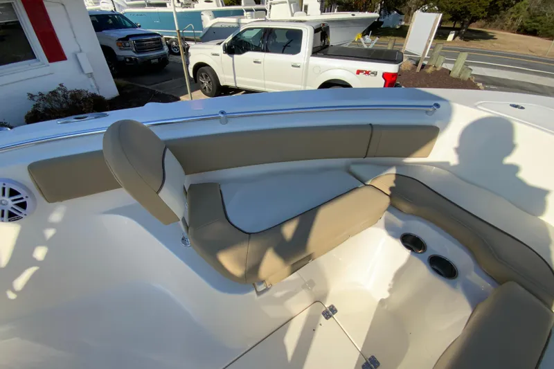 Slide: The Image of 2019 Key West 239 FS boat interior with beige seating and cup holders. - 24